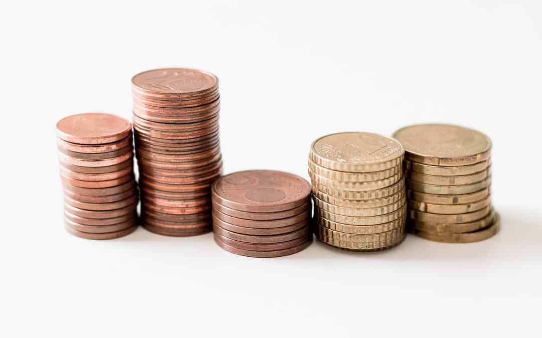 stacks of pennies and quarters on white background